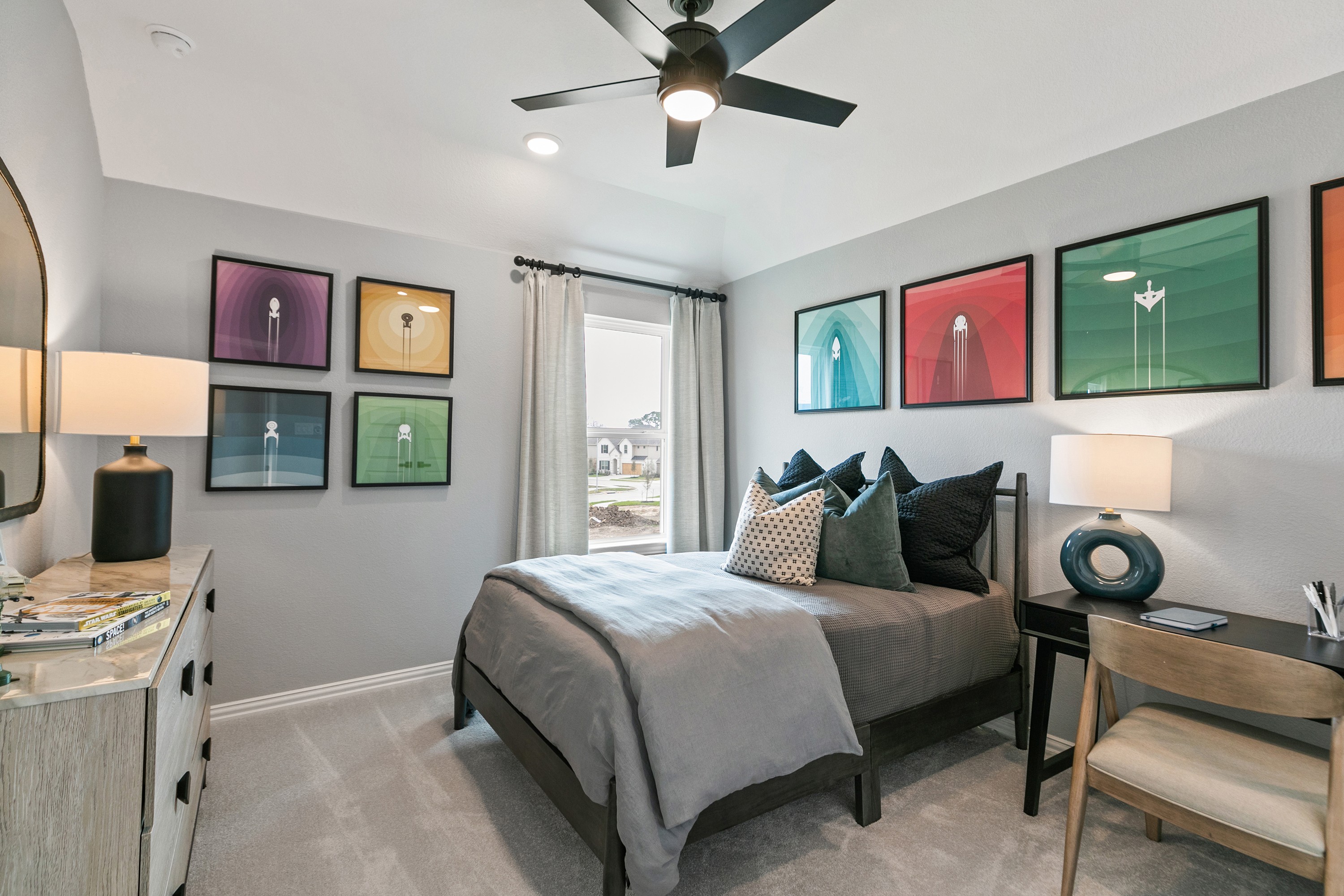 Modern Bedroom with Abstract Art at Park at Eldridge Community Modern bedroom with abstract art, sleek ceiling fan, natural light, Park at Eldridge community, luxury real estate.